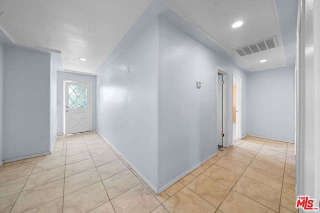 corridor featuring light tile patterned flooring