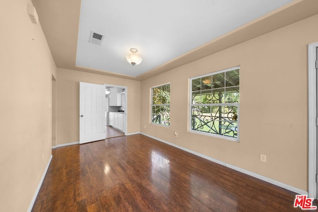 spare room featuring dark hardwood / wood-style flooring