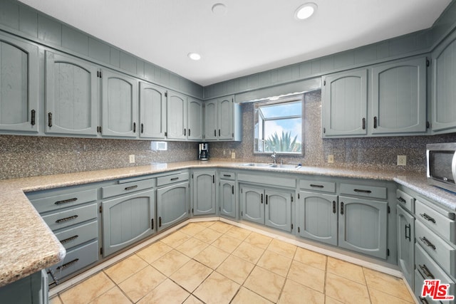 kitchen featuring gray cabinetry and light tile patterned flooring