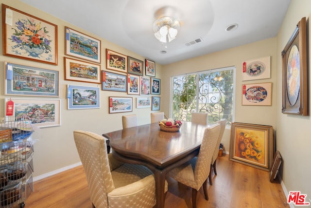 dining space featuring light wood-type flooring and ceiling fan