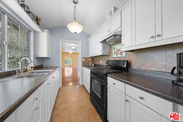 kitchen with white cabinetry, black gas stove, lofted ceiling, and a wealth of natural light