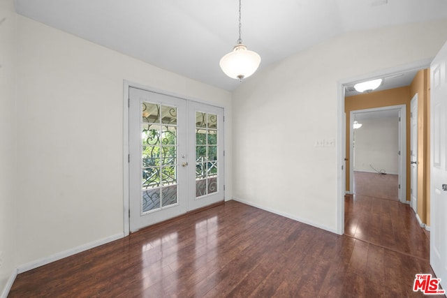 unfurnished room with dark hardwood / wood-style floors, vaulted ceiling, and french doors