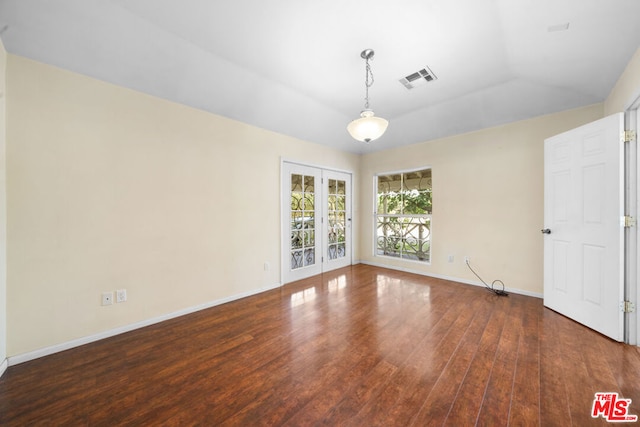 spare room with french doors, dark hardwood / wood-style flooring, and vaulted ceiling