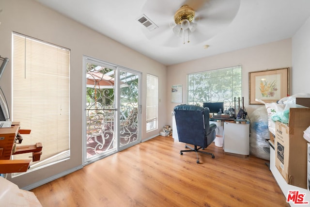 office space featuring ceiling fan and light hardwood / wood-style floors