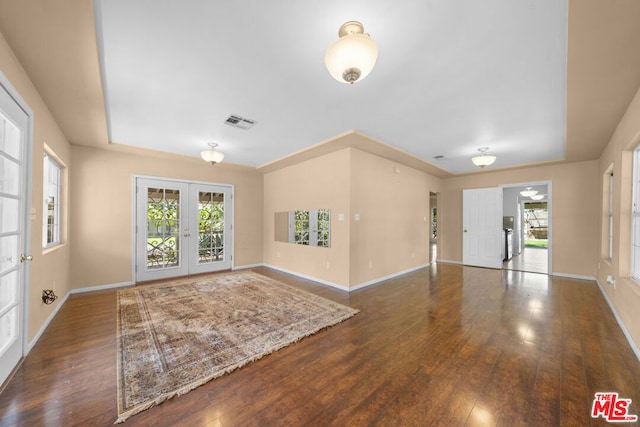 interior space featuring french doors, dark hardwood / wood-style flooring, ceiling fan, and a healthy amount of sunlight