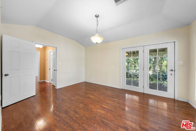 unfurnished room with dark wood-type flooring and lofted ceiling