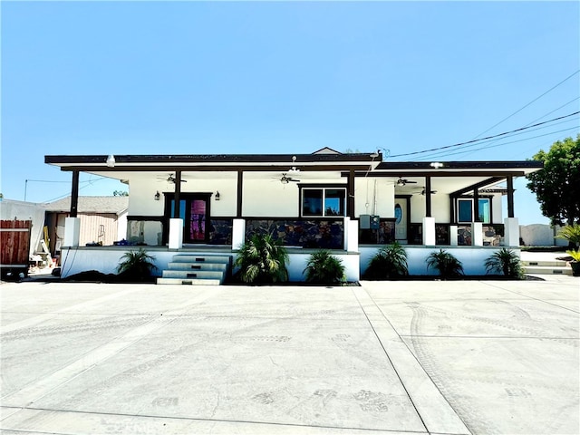 view of front of property featuring ceiling fan and covered porch