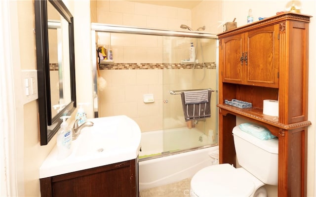 full bathroom featuring enclosed tub / shower combo, vanity, and toilet