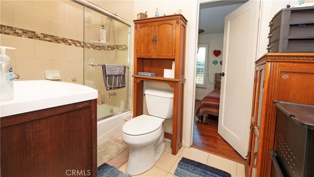 full bathroom featuring bath / shower combo with glass door, vanity, toilet, and wood-type flooring