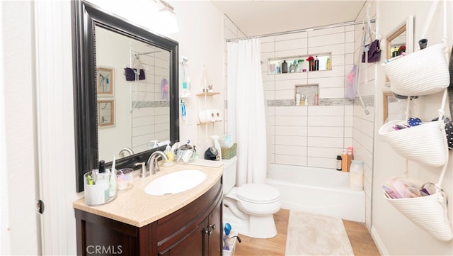 full bathroom featuring wood-type flooring, vanity, toilet, and shower / bath combo