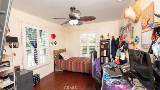 bedroom with ceiling fan and dark wood-type flooring