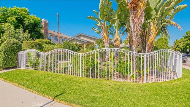 view of gate featuring a yard