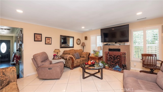 living room with light tile patterned flooring and a healthy amount of sunlight