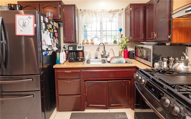 kitchen featuring range hood, appliances with stainless steel finishes, light tile patterned flooring, and sink