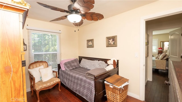 bedroom featuring ceiling fan and dark hardwood / wood-style flooring