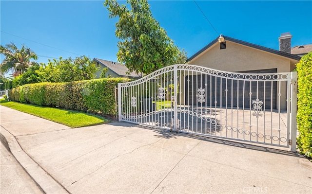 view of gate with a garage