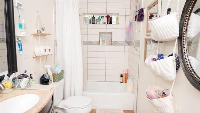 full bathroom featuring shower / bath combo, vanity, and toilet