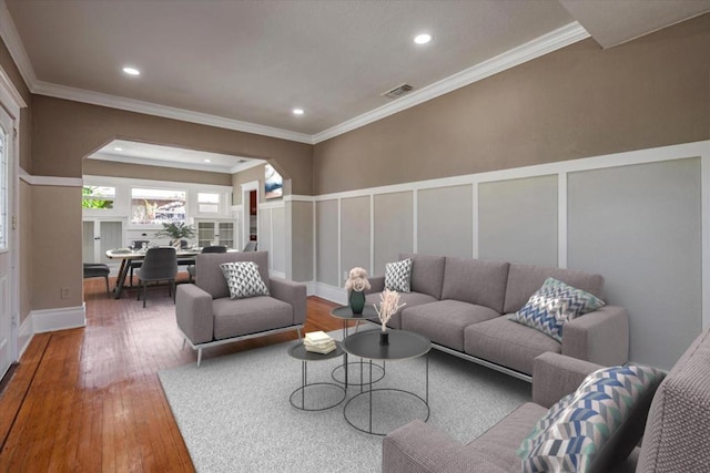 living room with hardwood / wood-style floors and crown molding