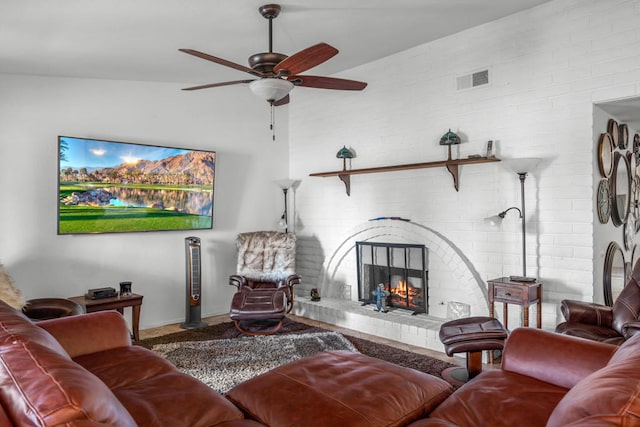 living room featuring ceiling fan and a fireplace