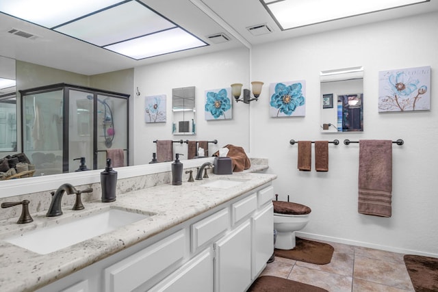 bathroom featuring vanity, tile patterned flooring, toilet, and a shower with door