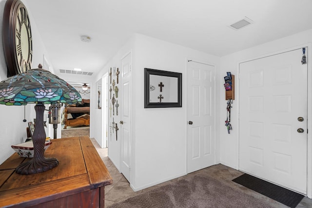 view of carpeted foyer