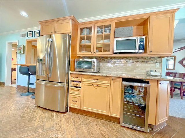 kitchen featuring wine cooler, tasteful backsplash, appliances with stainless steel finishes, ornamental molding, and light stone counters