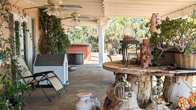 view of patio / terrace with a hot tub and ceiling fan