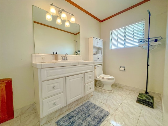 bathroom with vanity, ornamental molding, and toilet