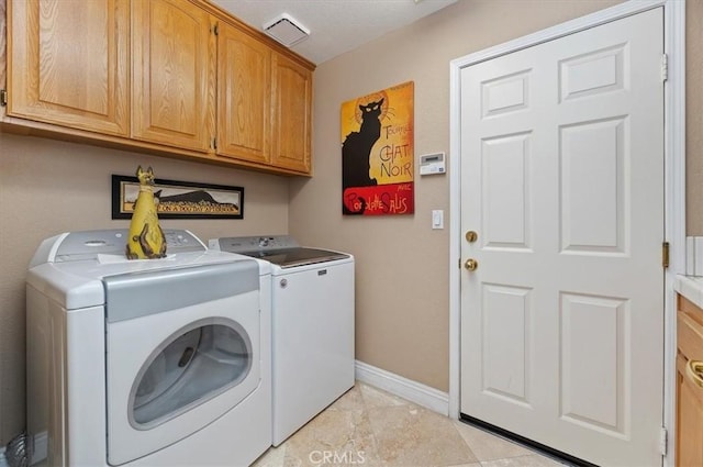 washroom with separate washer and dryer, light tile patterned flooring, and cabinets