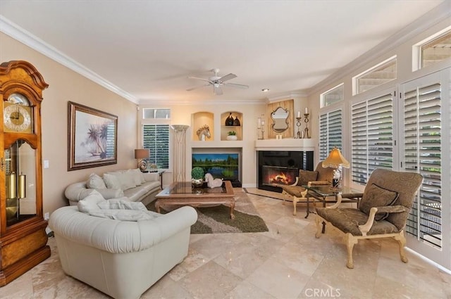 living room with built in shelves, ceiling fan, crown molding, and a wealth of natural light