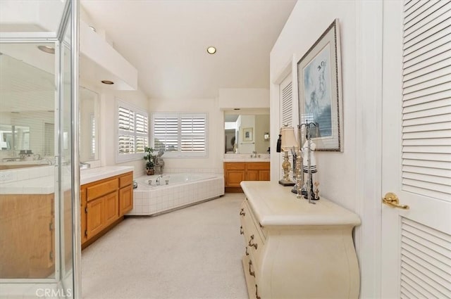 bathroom with vanity and independent shower and bath