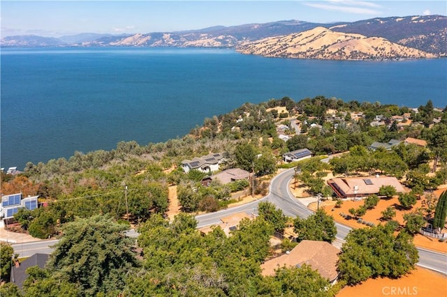 drone / aerial view with a water and mountain view