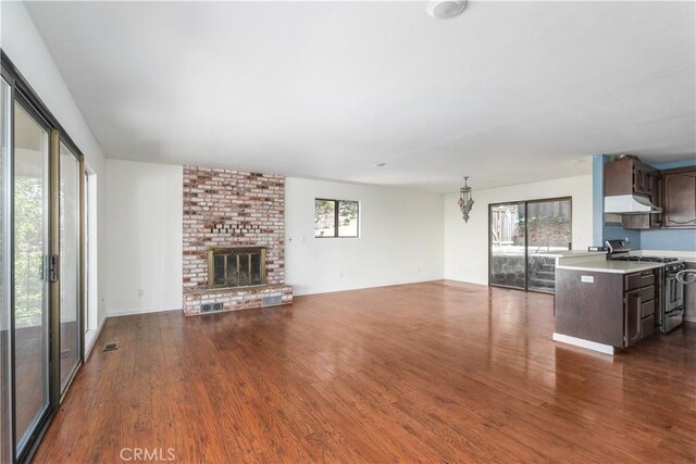 unfurnished living room with a fireplace and dark hardwood / wood-style floors