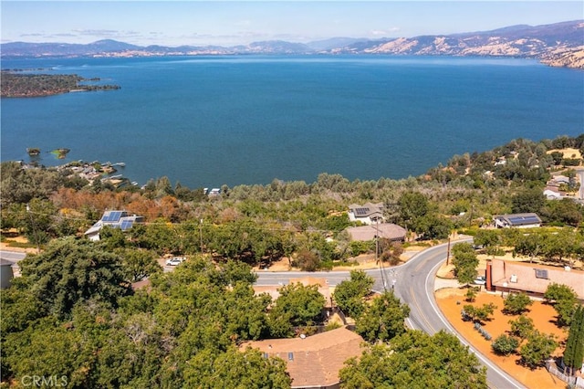 drone / aerial view with a water and mountain view