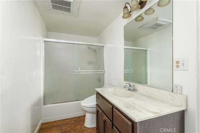 bathroom with visible vents, vanity, toilet, and wood finished floors