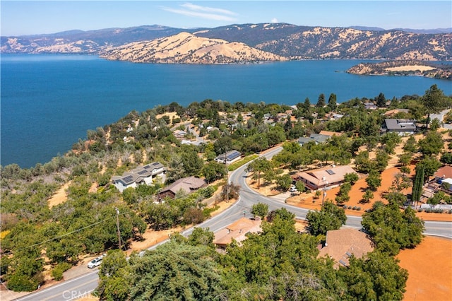 drone / aerial view featuring a water and mountain view