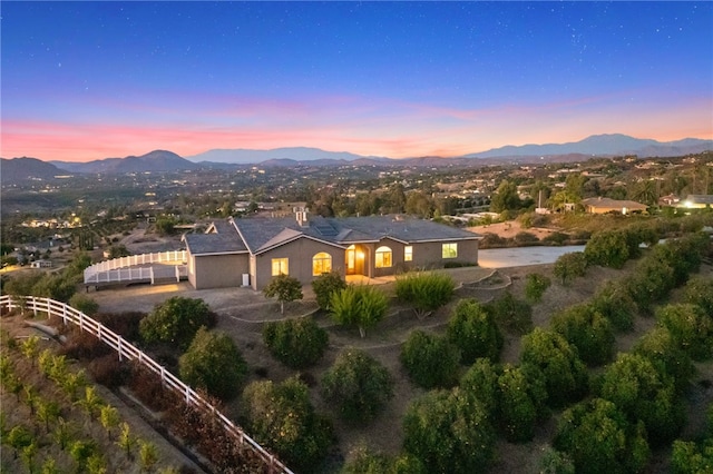 aerial view at dusk featuring a mountain view