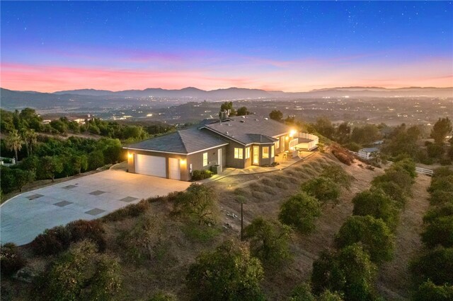 view of front of home with a mountain view and a garage