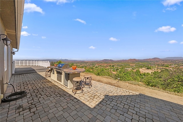 view of patio featuring a mountain view, grilling area, and area for grilling