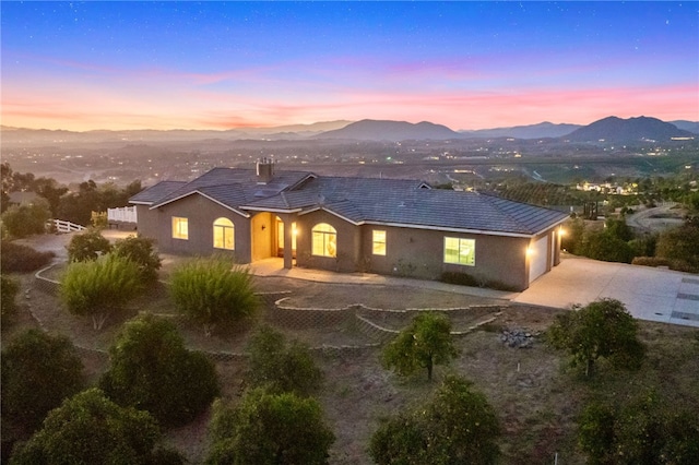 back house at dusk with a mountain view