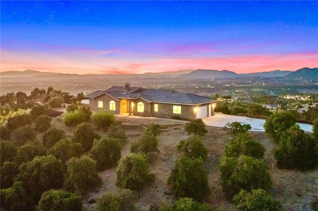 view of front of property with a garage and a mountain view