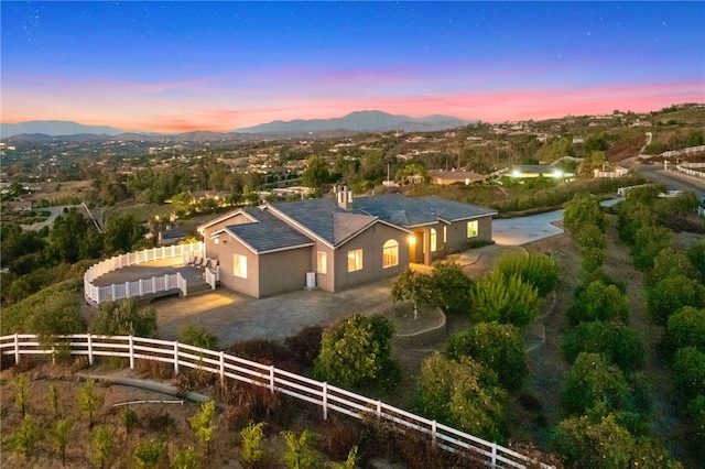 aerial view at dusk featuring a mountain view