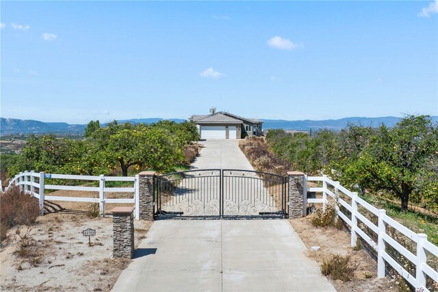 view of gate featuring a mountain view and a garage