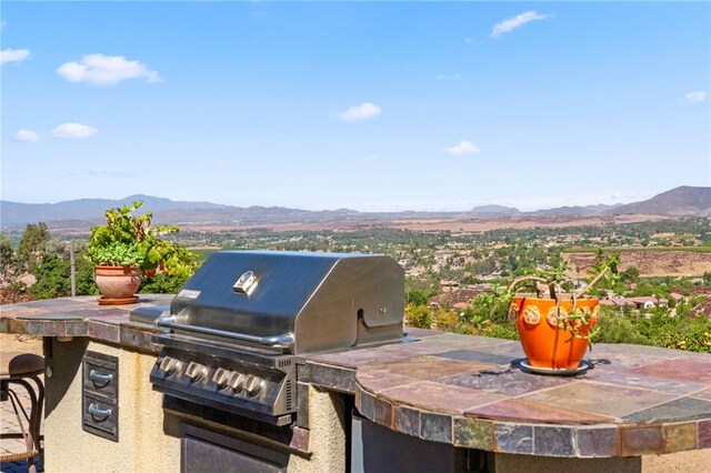 view of patio / terrace with a mountain view and area for grilling