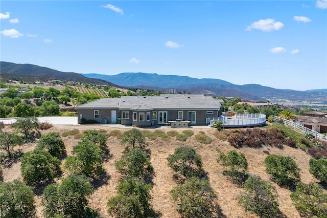 rear view of property featuring a mountain view