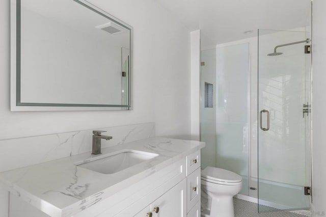 bathroom featuring tile patterned floors, an enclosed shower, vanity, and toilet