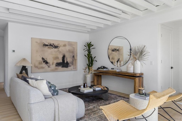 living room with light hardwood / wood-style floors and beamed ceiling