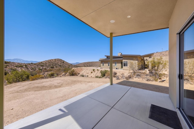 view of patio / terrace featuring a mountain view