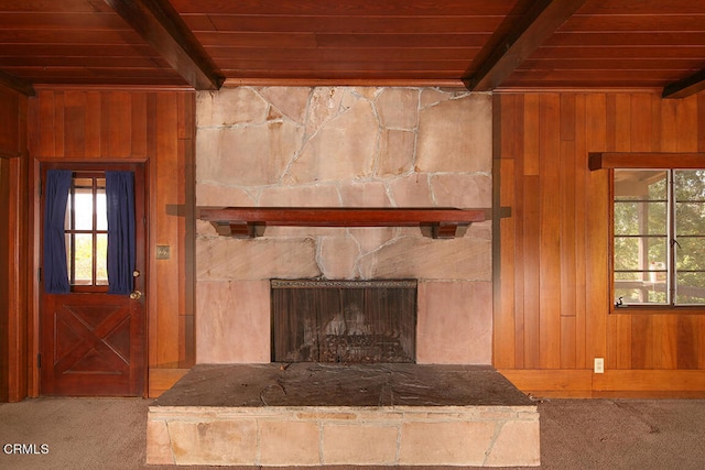 details featuring wood ceiling, wood walls, carpet flooring, and a stone fireplace