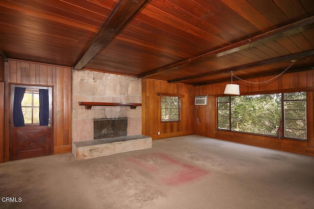 unfurnished living room featuring wooden walls, a fireplace, beam ceiling, and wood ceiling